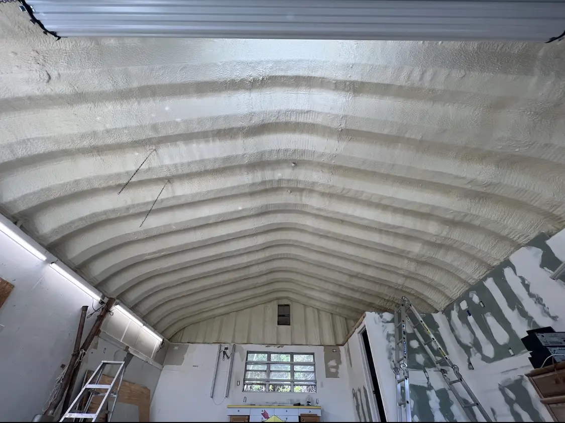 Spray polyurethane foam applied to the underside of a metal roof deck in Purcell